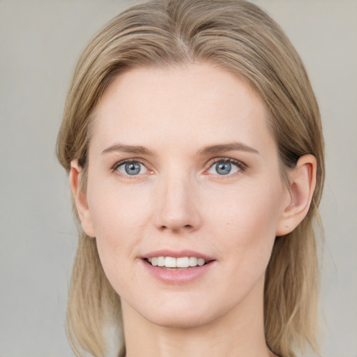 Joyful white young-adult female with medium  brown hair and blue eyes