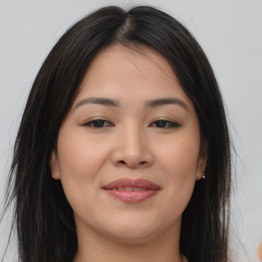 Joyful asian young-adult female with long  brown hair and brown eyes