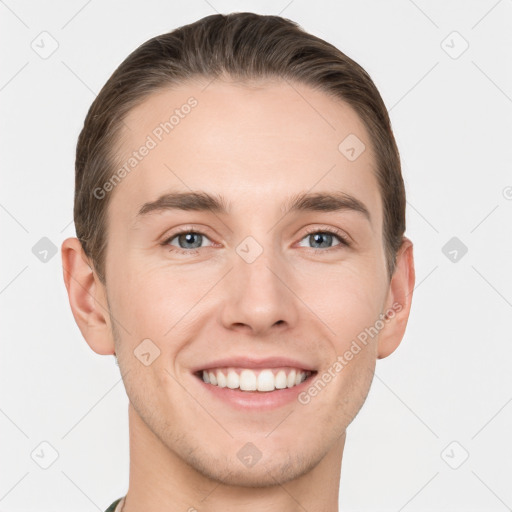 Joyful white young-adult male with short  brown hair and grey eyes