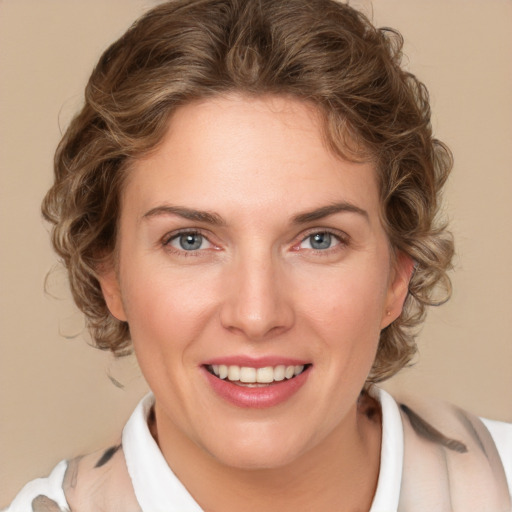 Joyful white young-adult female with medium  brown hair and blue eyes