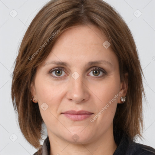 Joyful white adult female with medium  brown hair and grey eyes