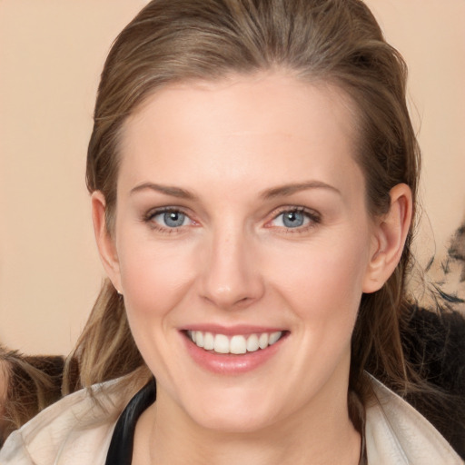 Joyful white young-adult female with long  brown hair and grey eyes