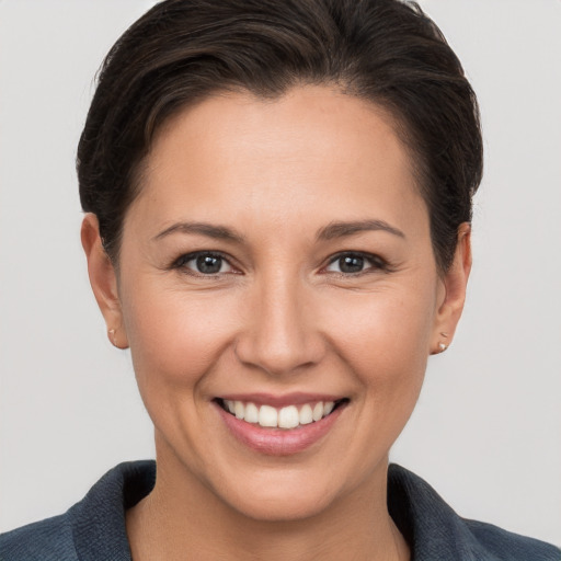 Joyful white young-adult female with short  brown hair and brown eyes