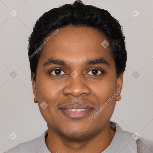 Joyful black young-adult male with short  black hair and brown eyes