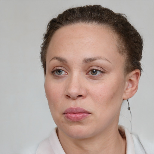 Neutral white young-adult female with short  brown hair and grey eyes