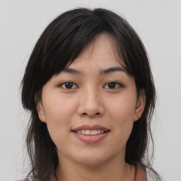 Joyful asian young-adult female with medium  brown hair and brown eyes