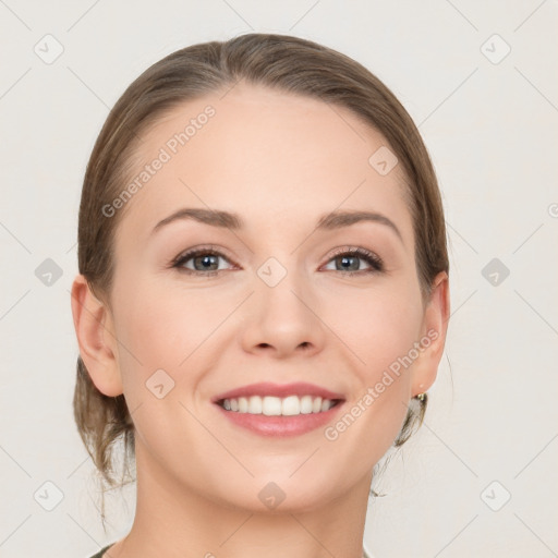 Joyful white young-adult female with medium  brown hair and grey eyes