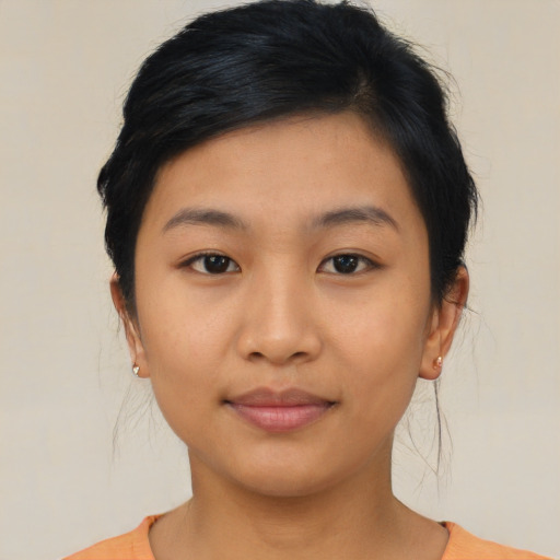Joyful asian young-adult female with medium  black hair and brown eyes