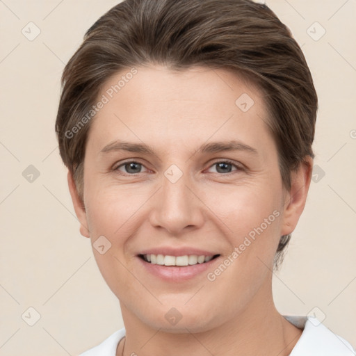 Joyful white young-adult female with short  brown hair and grey eyes