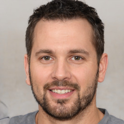 Joyful white adult male with short  brown hair and brown eyes