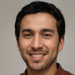 Joyful white young-adult male with short  black hair and brown eyes