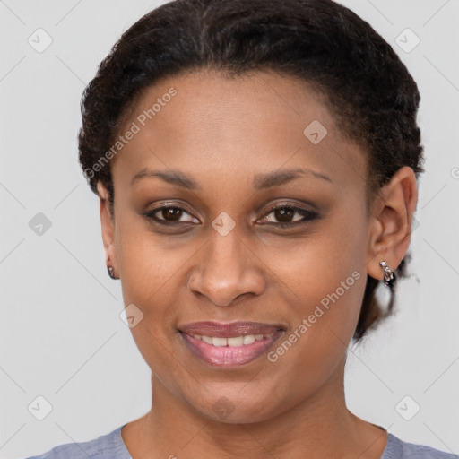 Joyful black young-adult female with short  brown hair and brown eyes