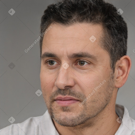 Joyful white adult male with short  black hair and brown eyes