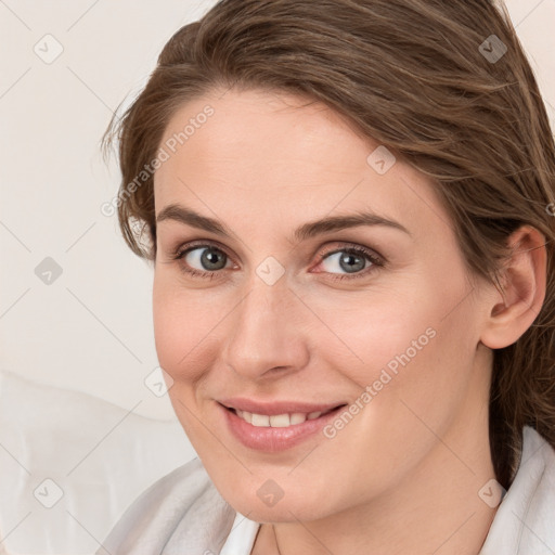 Joyful white young-adult female with medium  brown hair and blue eyes