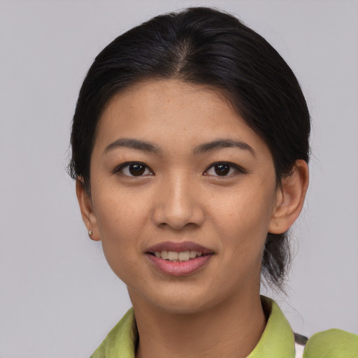 Joyful asian young-adult female with short  brown hair and brown eyes