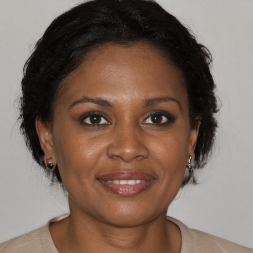 Joyful black adult female with medium  brown hair and brown eyes
