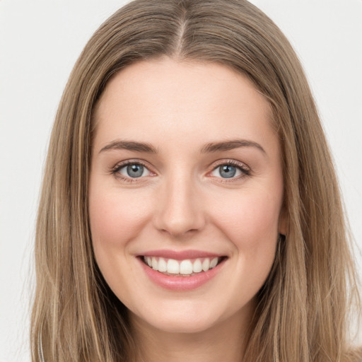 Joyful white young-adult female with long  brown hair and green eyes