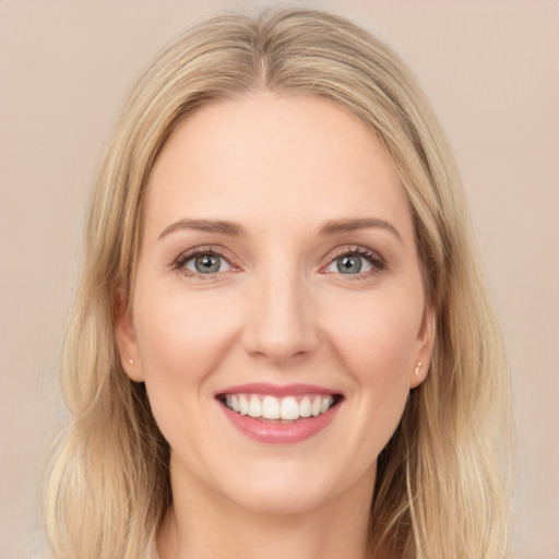 Joyful white young-adult female with long  brown hair and green eyes