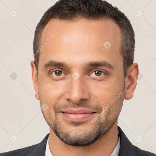 Joyful white adult male with short  brown hair and brown eyes