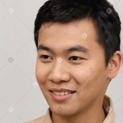 Joyful asian young-adult male with short  black hair and brown eyes