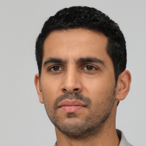Neutral latino young-adult male with short  black hair and brown eyes