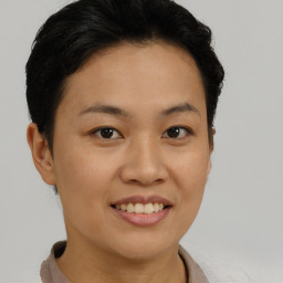 Joyful asian young-adult female with short  brown hair and brown eyes