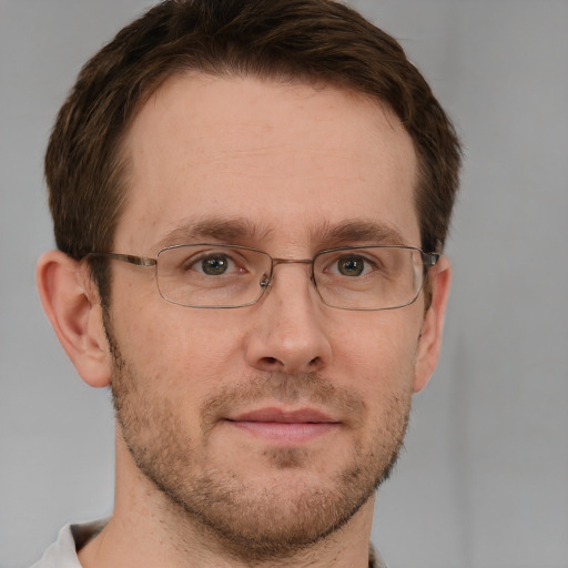 Joyful white adult male with short  brown hair and grey eyes