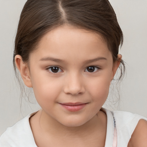 Joyful white child female with medium  brown hair and brown eyes