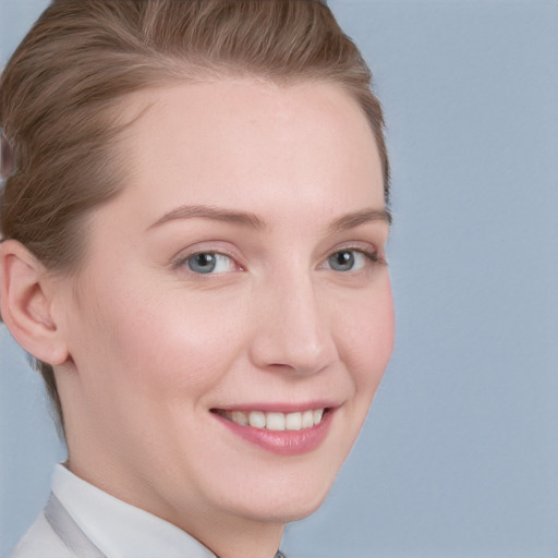 Joyful white young-adult female with short  brown hair and blue eyes