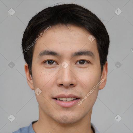 Joyful asian young-adult male with short  brown hair and brown eyes