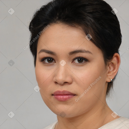 Joyful latino young-adult female with medium  brown hair and brown eyes