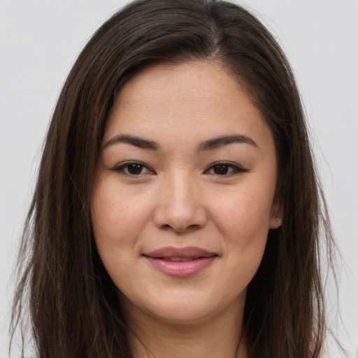 Joyful white young-adult female with long  brown hair and brown eyes