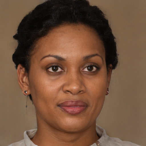 Joyful black adult female with short  brown hair and brown eyes