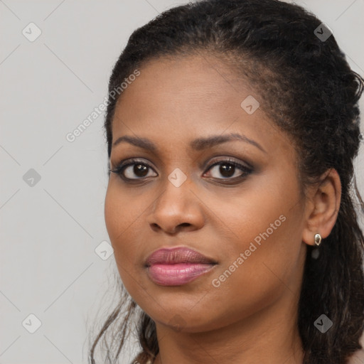 Joyful black young-adult female with long  brown hair and brown eyes