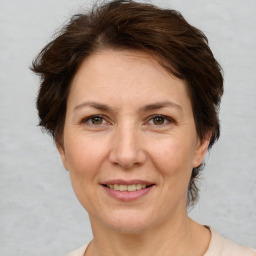 Joyful white adult female with short  brown hair and brown eyes