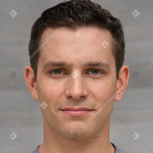 Joyful white young-adult male with short  brown hair and grey eyes