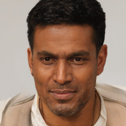 Neutral latino adult male with short  brown hair and brown eyes