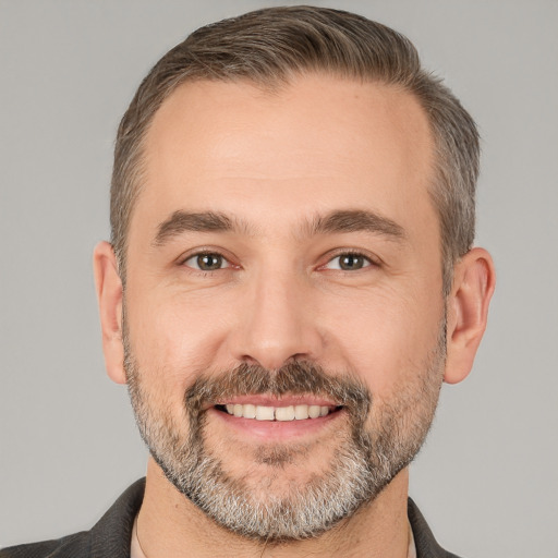 Joyful white adult male with short  brown hair and brown eyes