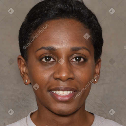 Joyful black young-adult female with short  black hair and brown eyes