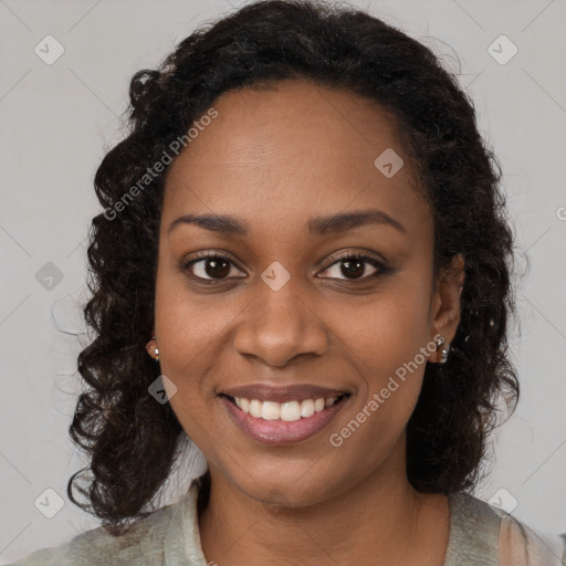 Joyful black young-adult female with long  brown hair and brown eyes