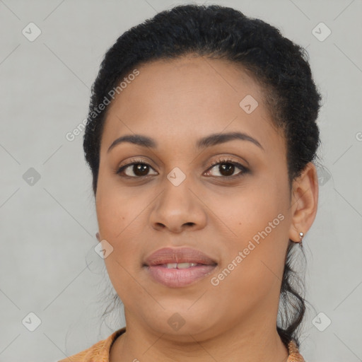 Joyful black young-adult female with long  brown hair and brown eyes