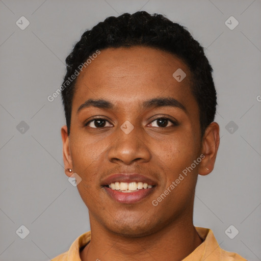 Joyful black young-adult male with short  black hair and brown eyes