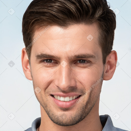 Joyful white young-adult male with short  brown hair and brown eyes