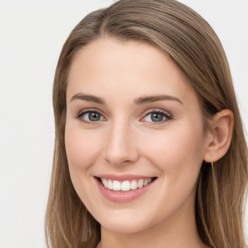 Joyful white young-adult female with long  brown hair and grey eyes