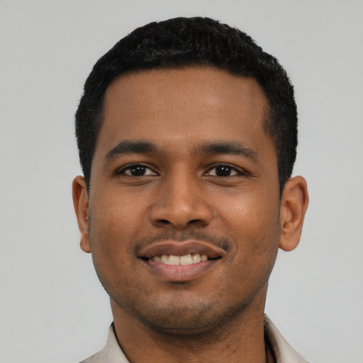 Joyful latino young-adult male with short  black hair and brown eyes