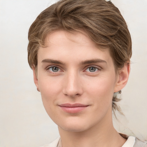 Joyful white young-adult female with medium  brown hair and grey eyes