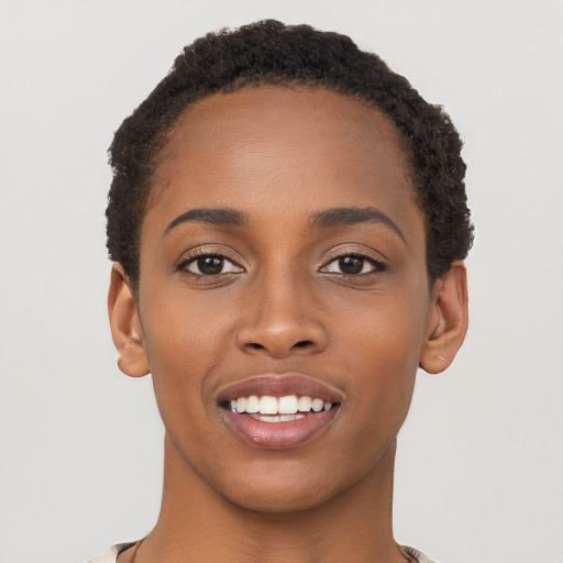 Joyful black young-adult female with short  brown hair and brown eyes