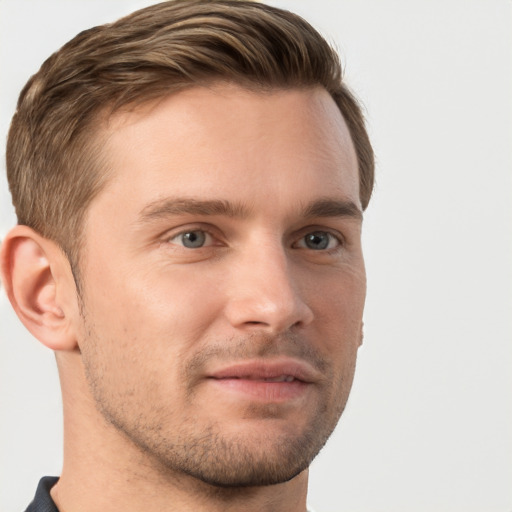 Joyful white young-adult male with short  brown hair and grey eyes