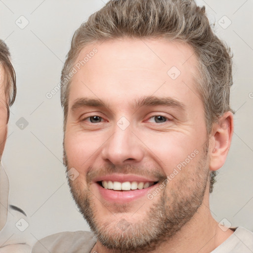 Joyful white young-adult male with short  brown hair and brown eyes