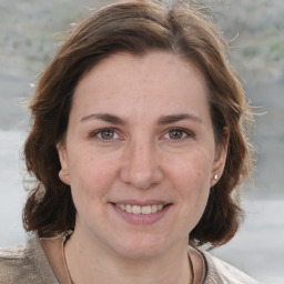 Joyful white young-adult female with medium  brown hair and brown eyes